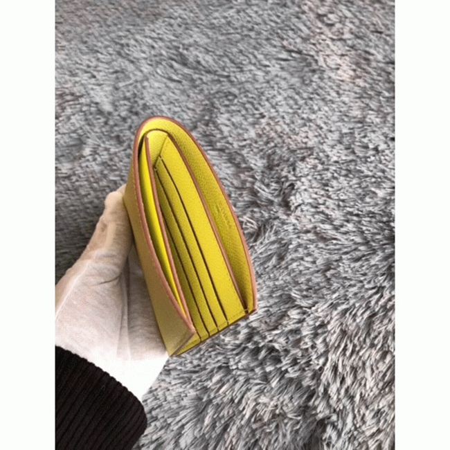 Yellow knockoff H**me5 Copernic compact wallet